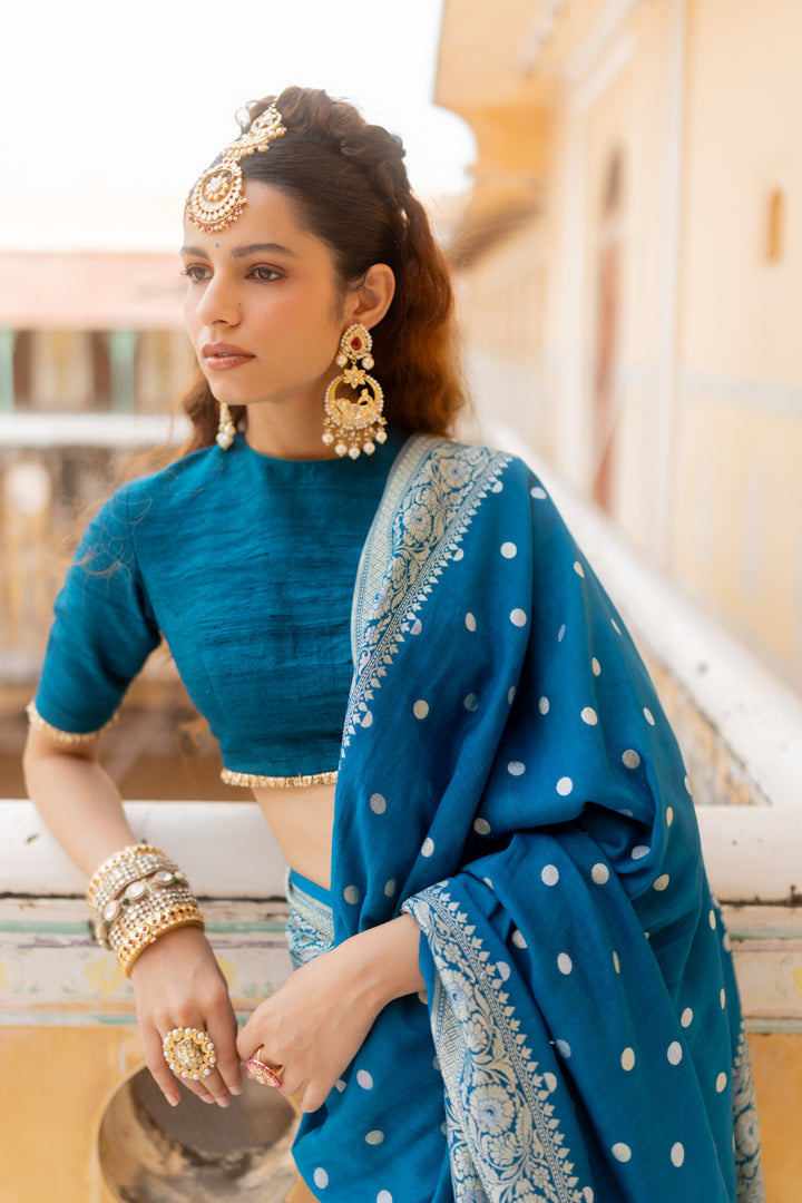 Elegant teal saree that reflects sophistication, tradition and regal ethnic look